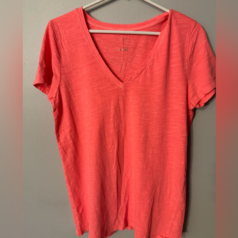 Salmon colored v neck opening